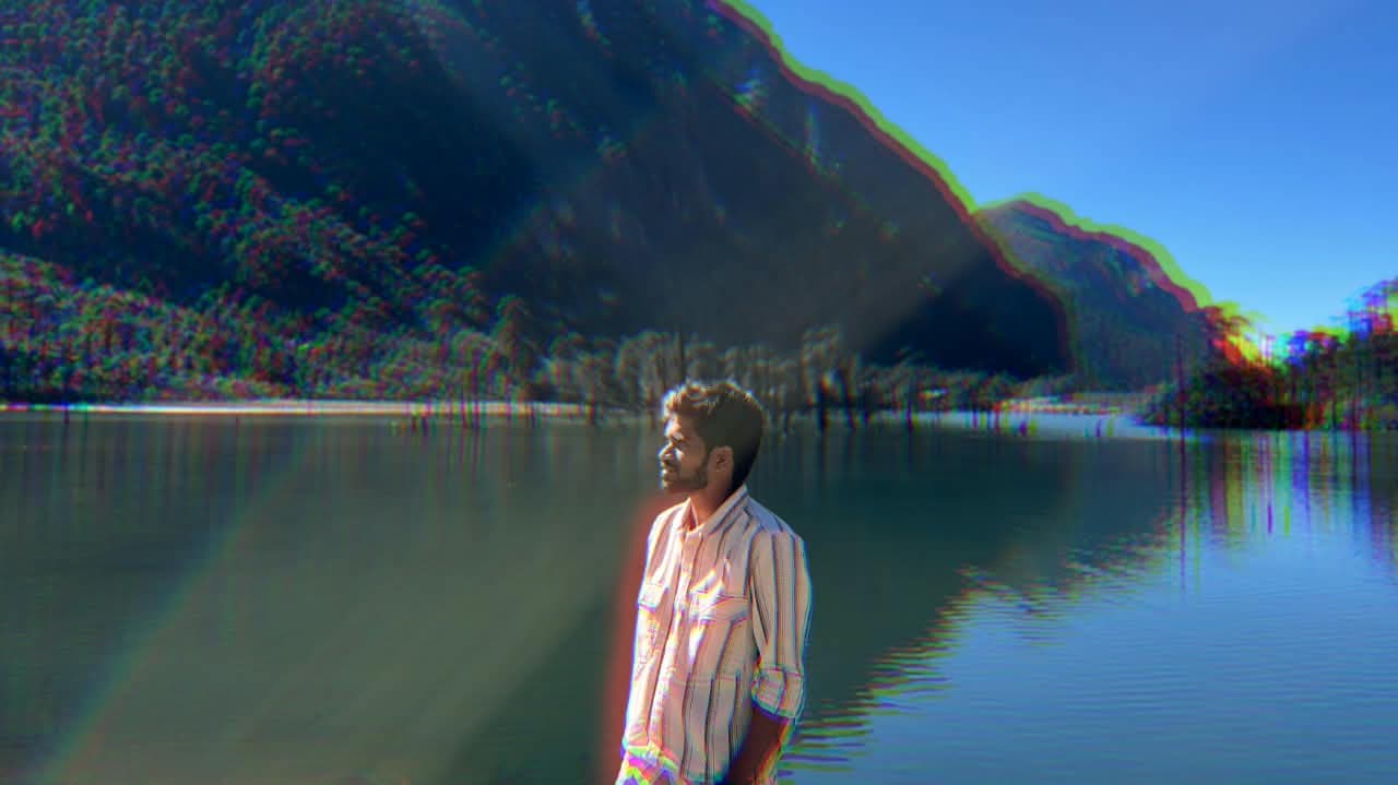 Vamshi beside a mountain lake, new perspective