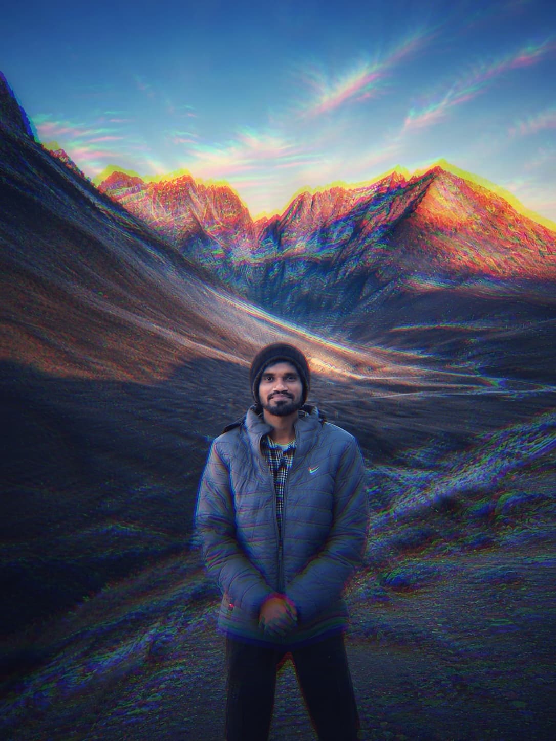 Vamshi standing in a mountain valley